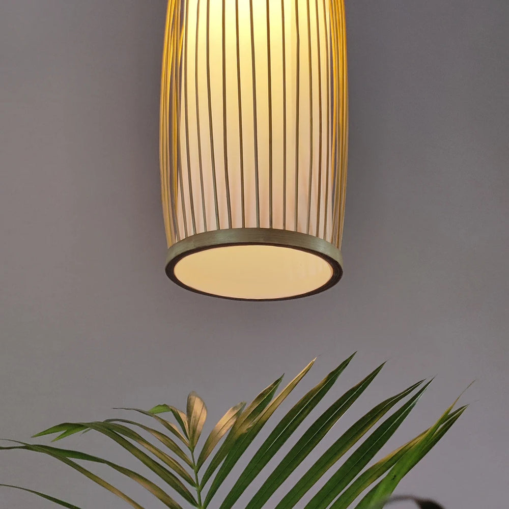 Side view of the Celocia Bamboo Hanging Lamp handcrafted by women artisans, showcasing its elegant cylindrical design