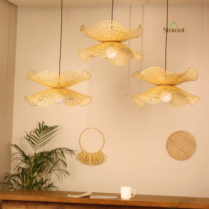 Bamboo Woven pendant lights hanging against a neutral wall with decorative elements.