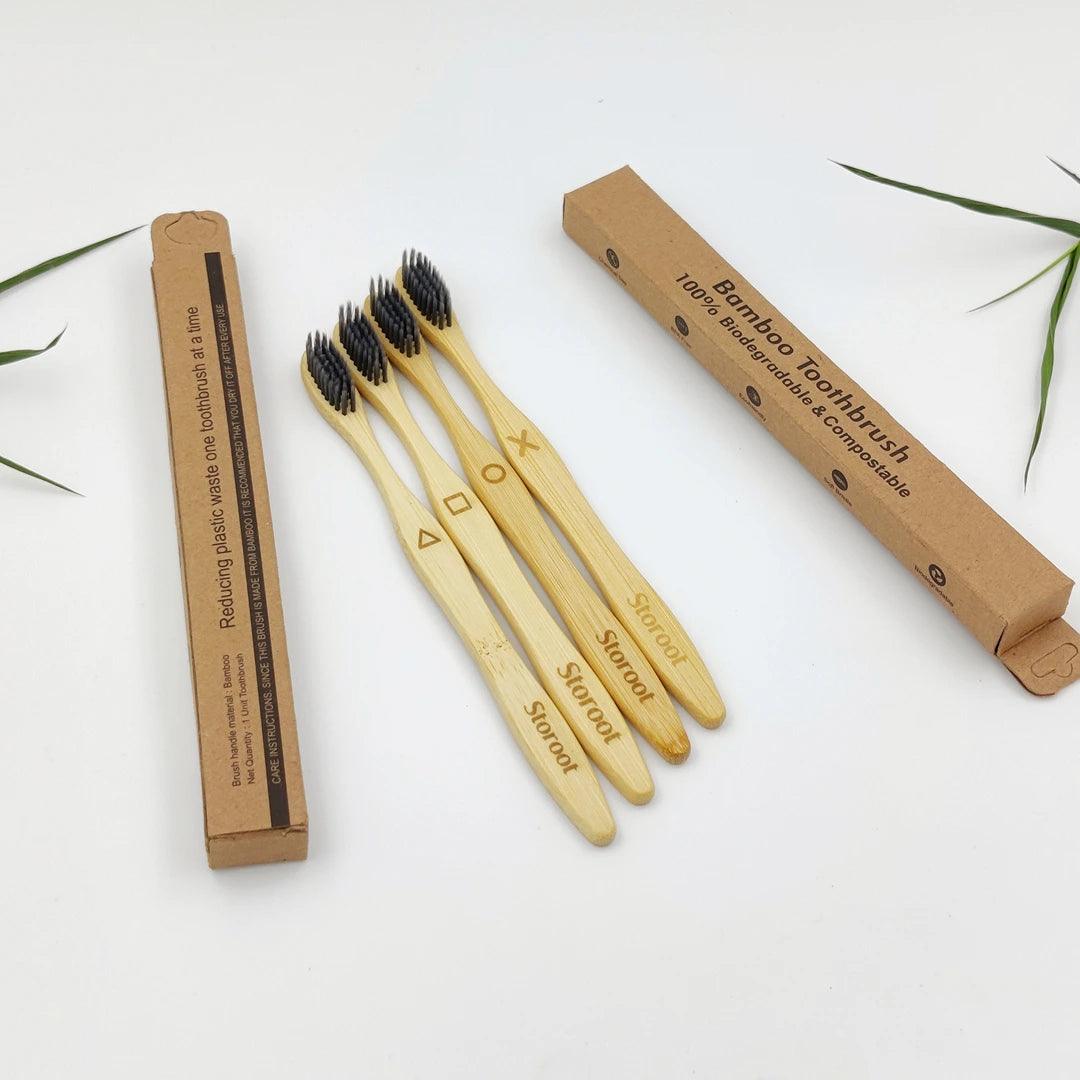 A set of four bamboo charcoal-infused toothbrushes from Storoot, displayed with eco-friendly packaging.