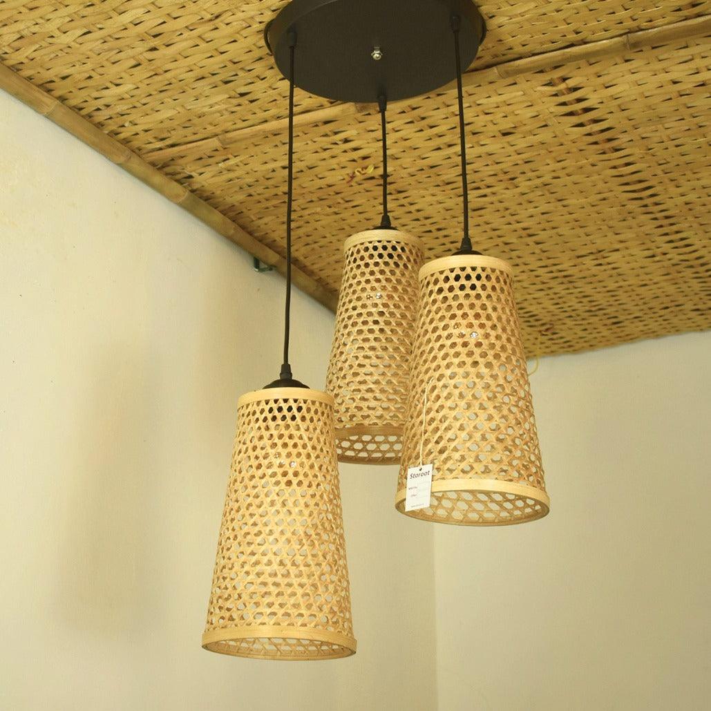 Cluster of three bamboo conical shades hanging from a ceiling