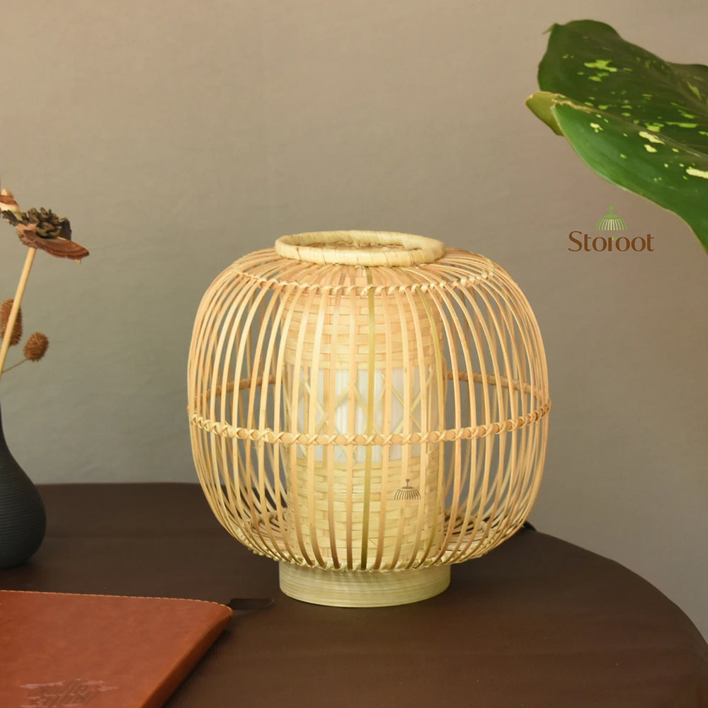 Side view of Huba Bamboo Table Lamp on a wooden table.