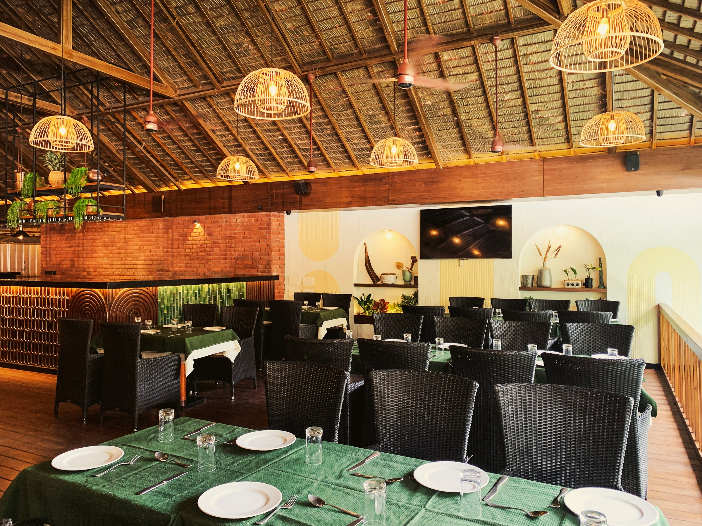 Elegant bamboo pendant lights illuminating a cozy restaurant interior, adding warmth and eco-friendly charm.